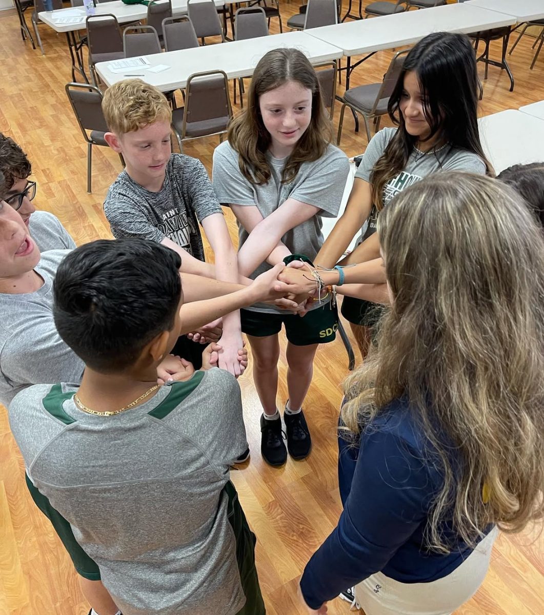 Saint David kids share kindness in a group gathering. 