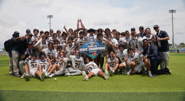 The 2025 varsity lacrosse team celebrates winning the state championship.