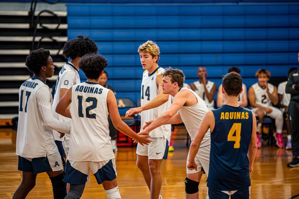 Joseph Virginio, John Virginio, Luke Swadener, Kamaal Medina, Christian Nicholson, and Elijah Lam celebrate in a group huddle after earning a point against the Wildcats.

Photo Courtesy of AQUINAS ATHLETICS