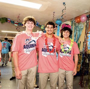 Juniors Blake Fernandez, Brooklyn Quinonez, and Derek Ruoff sporting their class shirts and Hawaiian leis.
