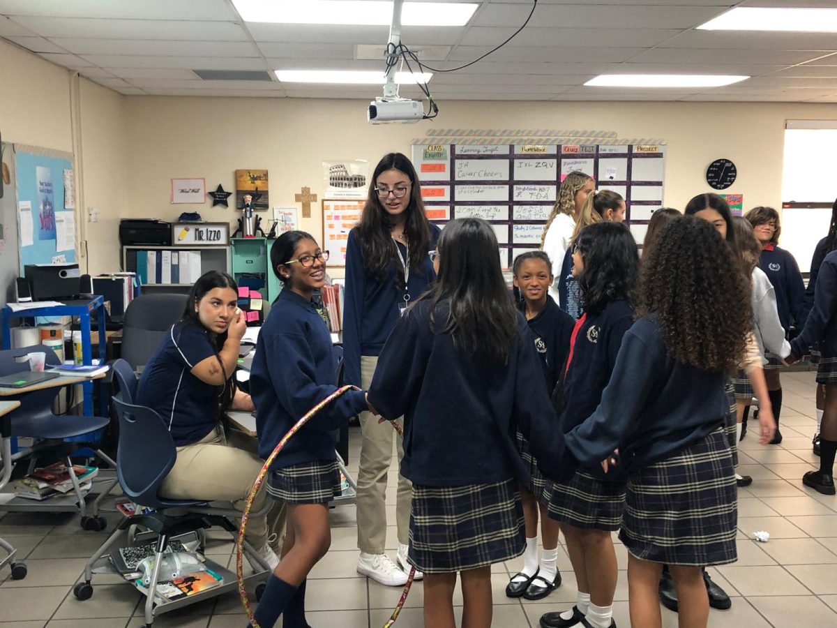 Semiors Siena Bergey and Arantxa Gil engaging with middle school students at St. Andrews Catholic School.
