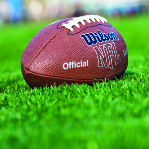 A NFL football awaits in the turf ready for kickoff

By: Jacob Tyler