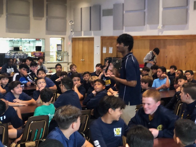 Senior Roshan Kusuma leading a discussion with elementary school students at Nativity Catholic School.