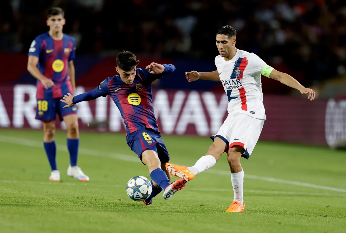 Pedri Gonzalez dribbling over PSG defender Hamkimi. 

Image via Getty Images