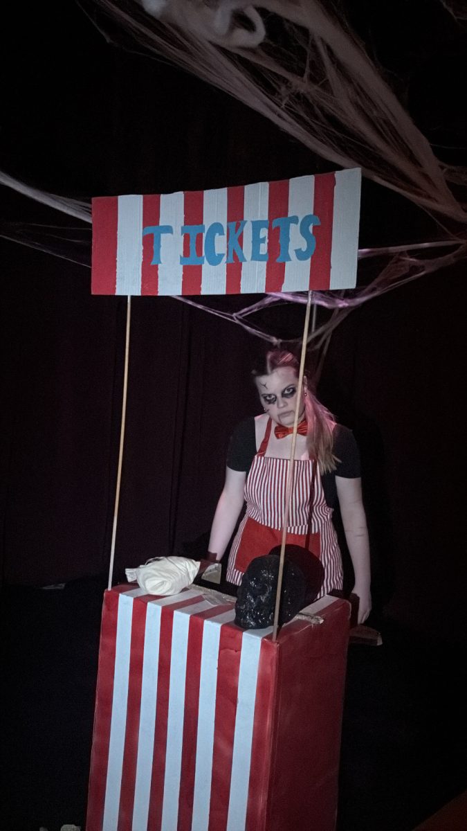 Sophomore, Juliana Bohm, greets guests at the Abandoned Circus.
