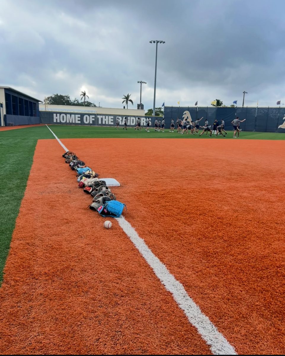 Athletes stretch together prior to demonstrating their skills on the field.