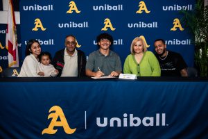 Senior, Yuniel Paredes, signs his commitment to Daytona State College to pursue his baseball career, as his family looks on with pride. Joined by his parents, siblings, and his 18 month old niece Aviannah, Yuniel is looking forward to a championship baseball season with STA.