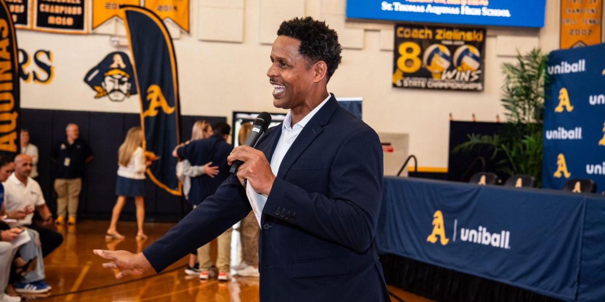 Coach Russell Introducing the 2026 signing class. (Courtesy of Aquinas Athletics)