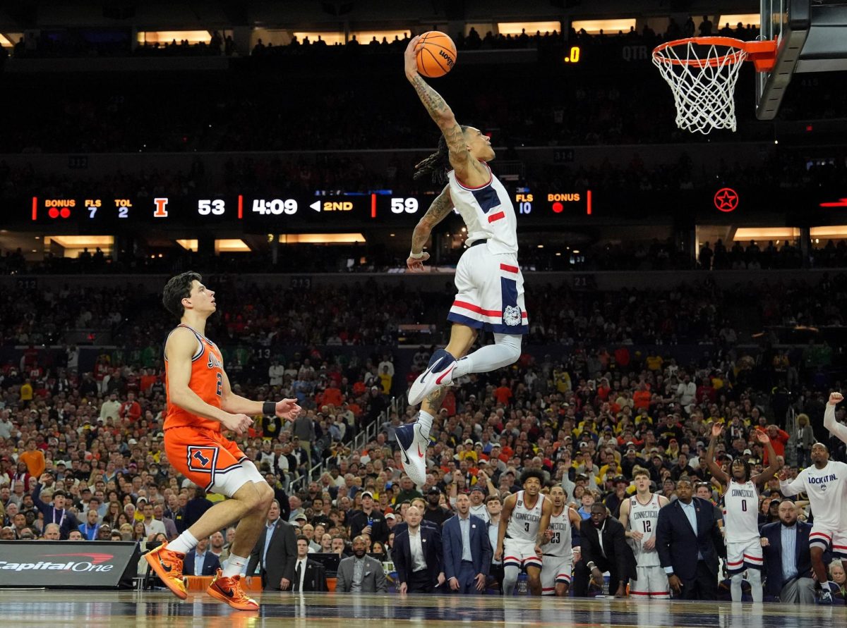 Apr 4, 2026; Indianapolis, IN, USA; UConn Huskies guard Solo Ball (1) dunks against the Illinois Fighting Illini during the second half of a semifinal of the Final Four of the men's 2026 NCAA Tournament at Lucas Oil Stadium. Bob Donnan-Imagn Images